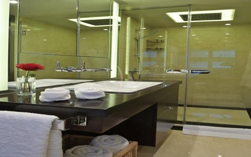 a bathroom with a countertop sink and a large mirror aboard TATIANA I Yacht for Sale