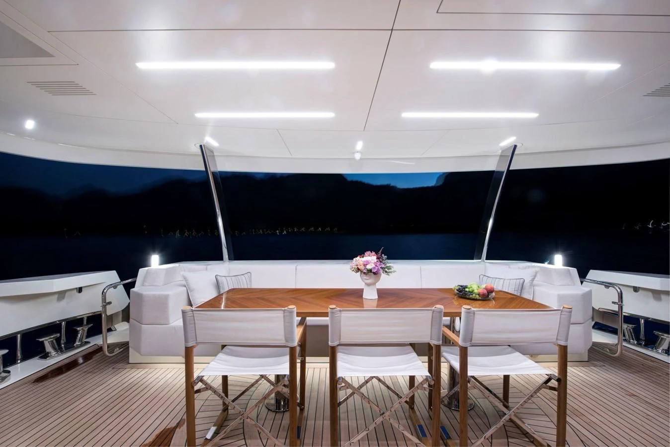 a table with chairs and a large blue wall in the background aboard SANDRO Yacht for Sale