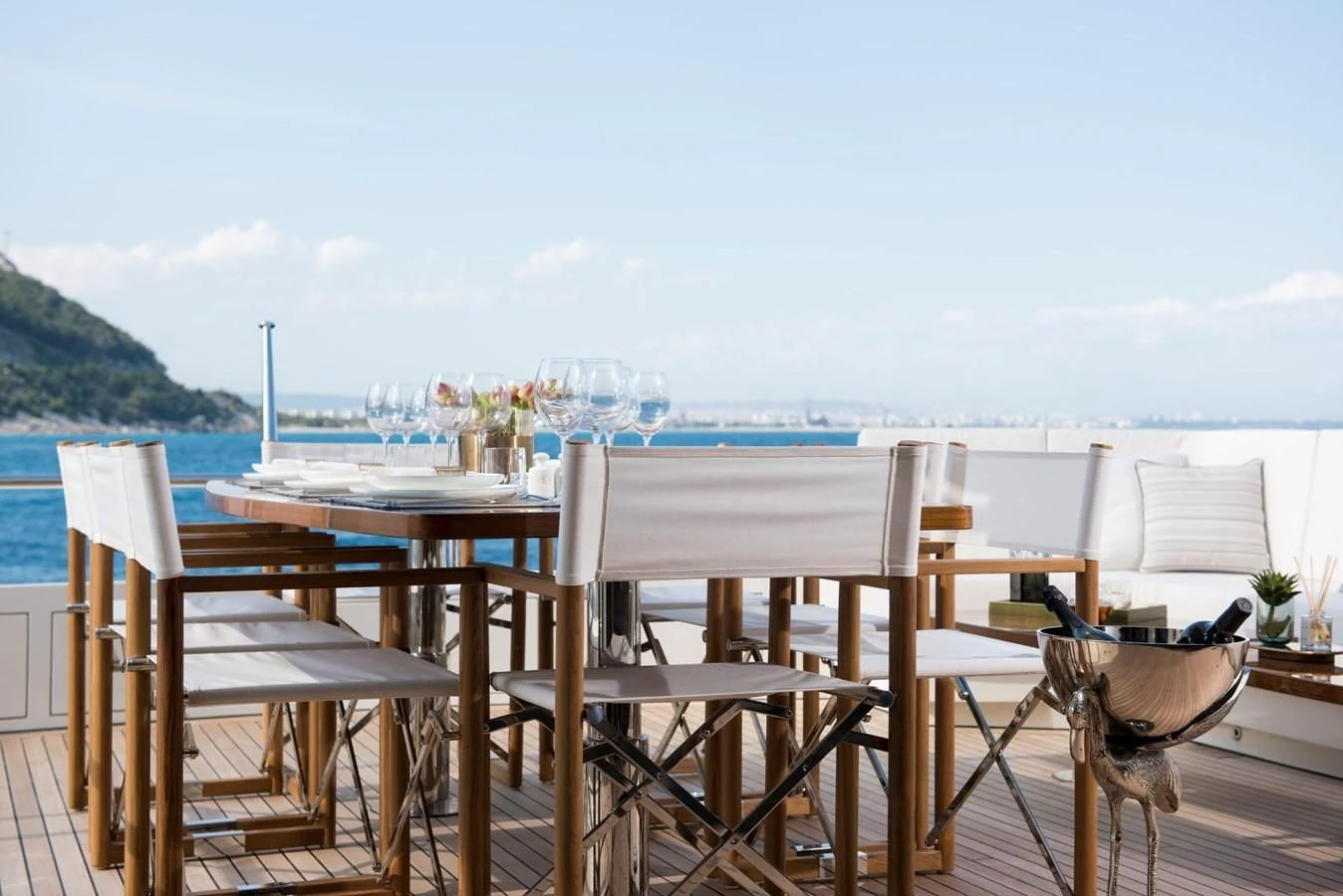 a table and chairs on a deck overlooking a body of water aboard SANDRO Yacht for Sale