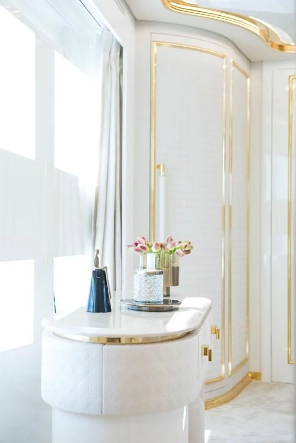 a white pedestal with a vase of flowers on it aboard SANDRO Yacht for Sale