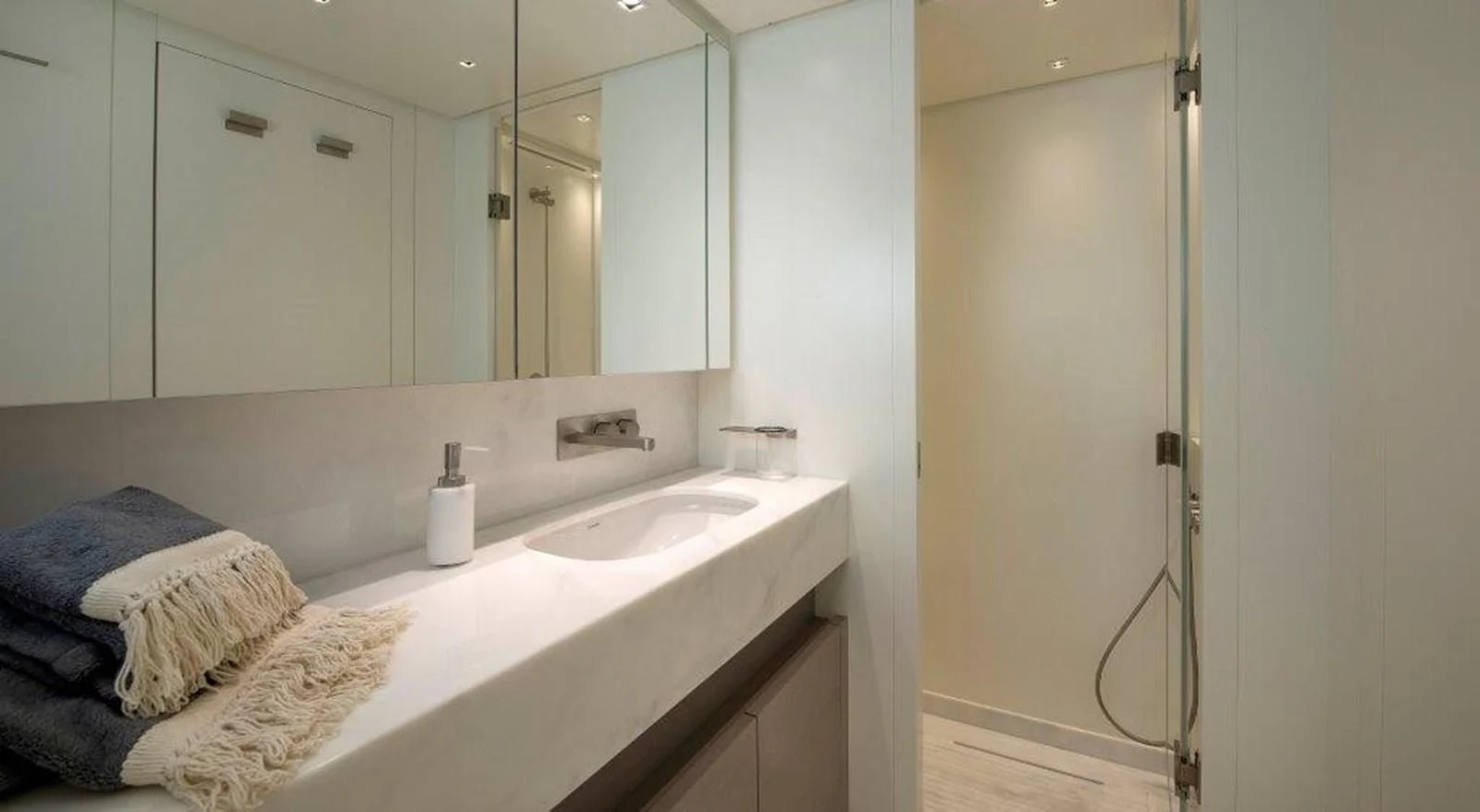a bathroom with a large mirror aboard SEN Yacht for Sale