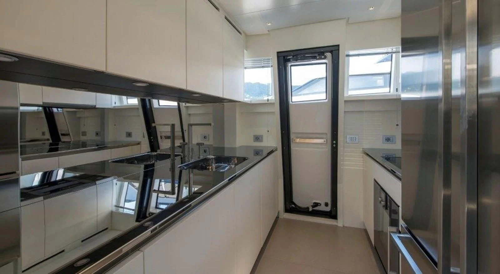a kitchen with white cabinets aboard SEN Yacht for Sale