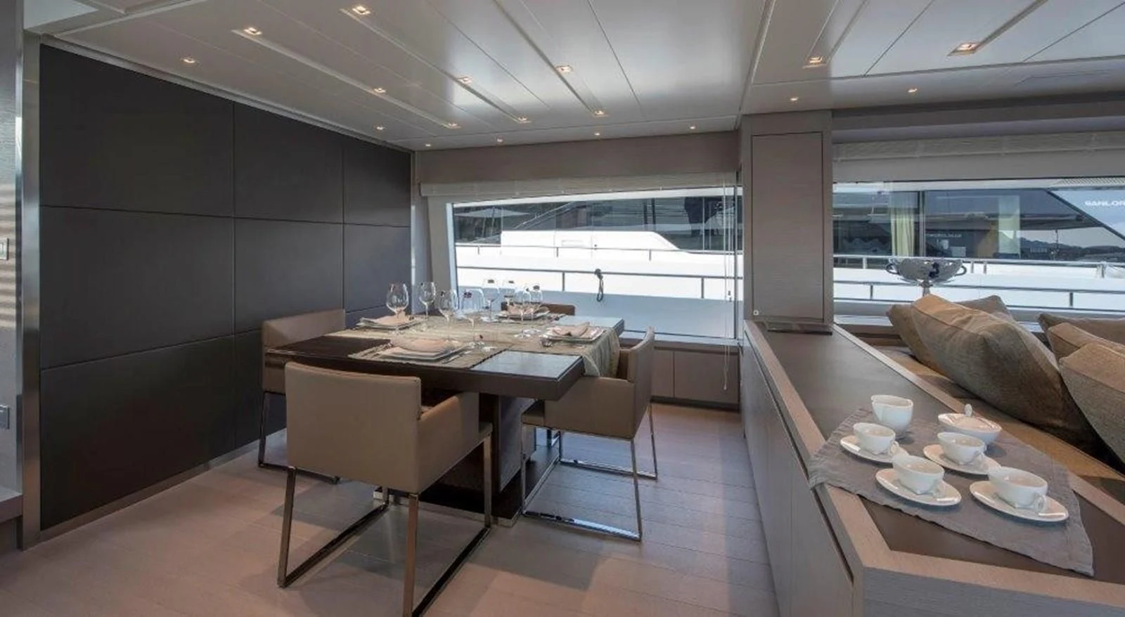 a modern looking kitchen with a dining table and chairs aboard SEN Yacht for Sale