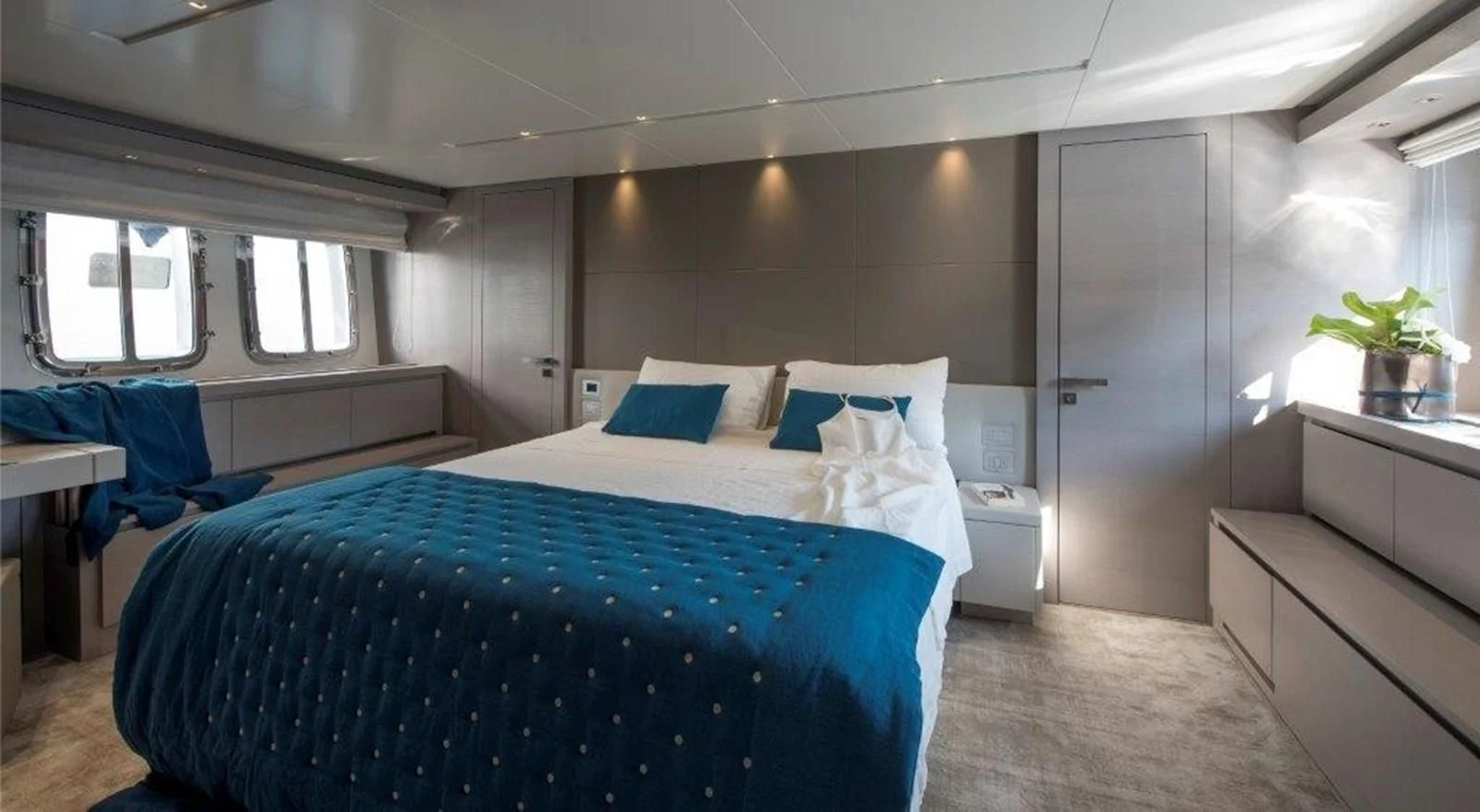 a bedroom with a bed and a desk aboard SEN Yacht for Sale
