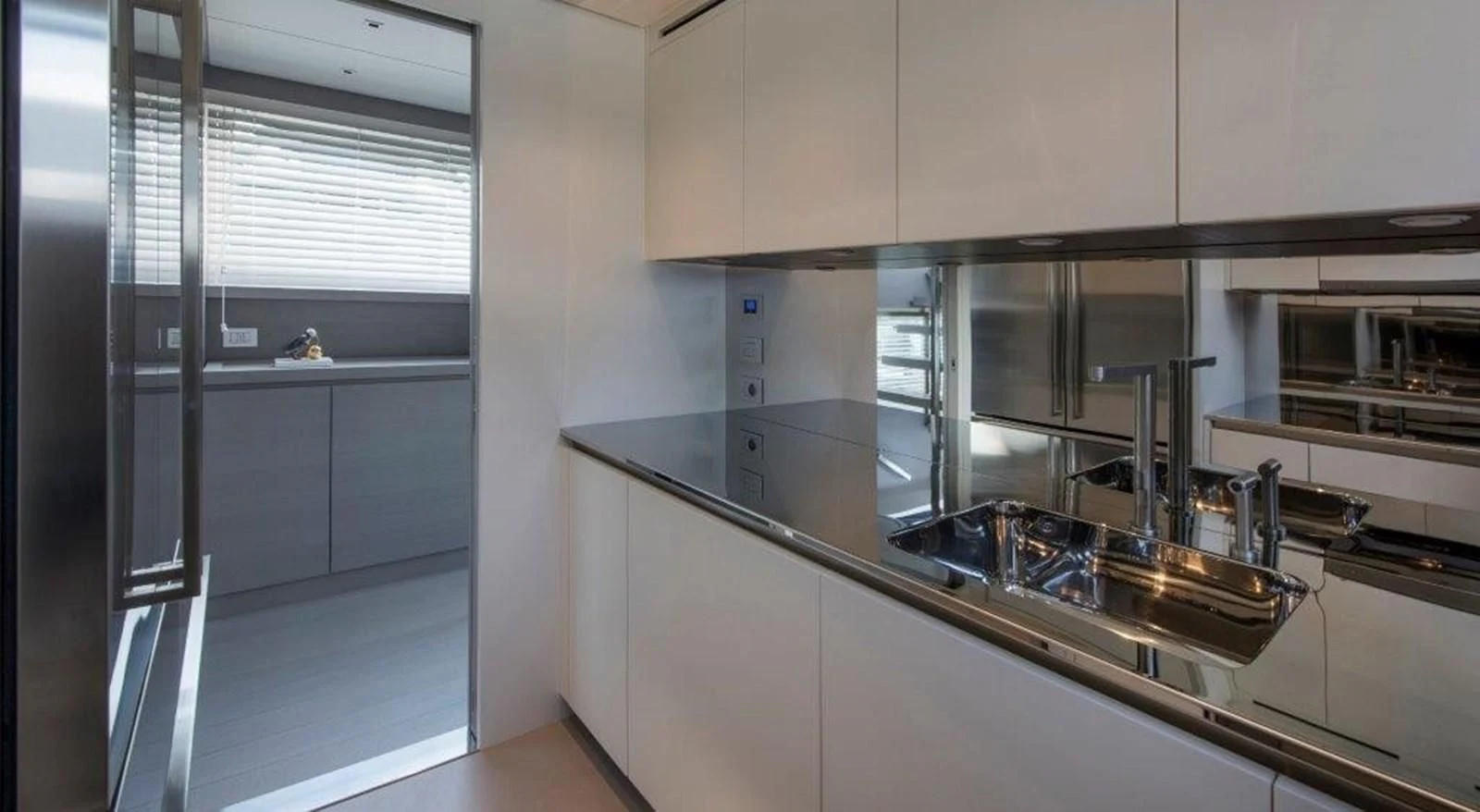 a kitchen with a sink and cabinets aboard SEN Yacht for Sale