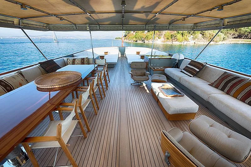 a deck with chairs and tables on it aboard JURA II Yacht for Sale