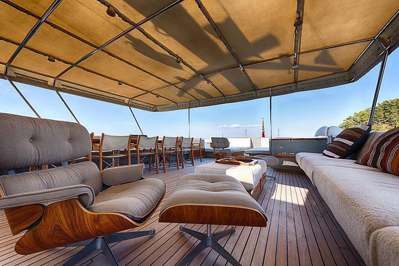 a large living room with a wood floor and a large window aboard JURA II Yacht for Sale