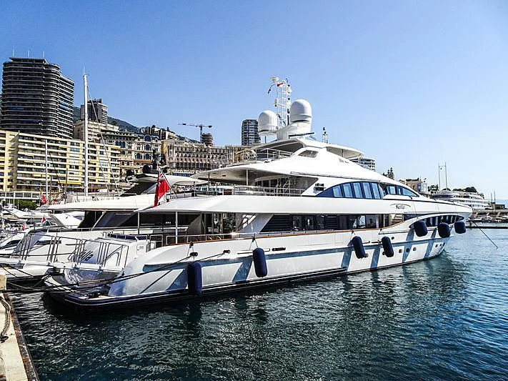 a large white boat in a harbor aboard YALLA Yacht for Sale