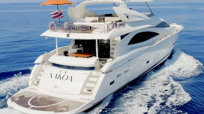 a white yacht on the water aboard NAKOA Yacht for Sale