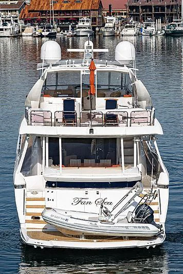 a white boat in a harbor aboard NAKOA Yacht for Sale