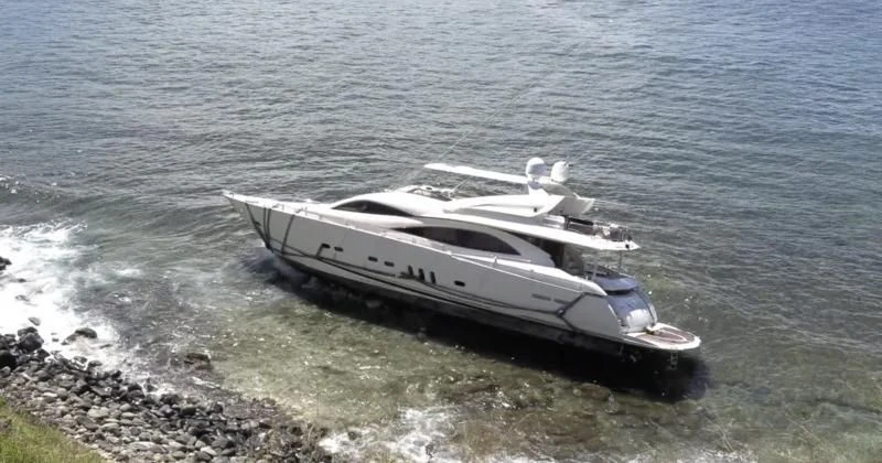 a boat on a rocky shore aboard NAKOA Yacht for Sale