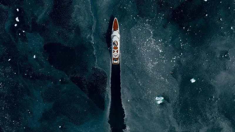 a rocket flying over a planet aboard INFINITE JEST Yacht for Sale