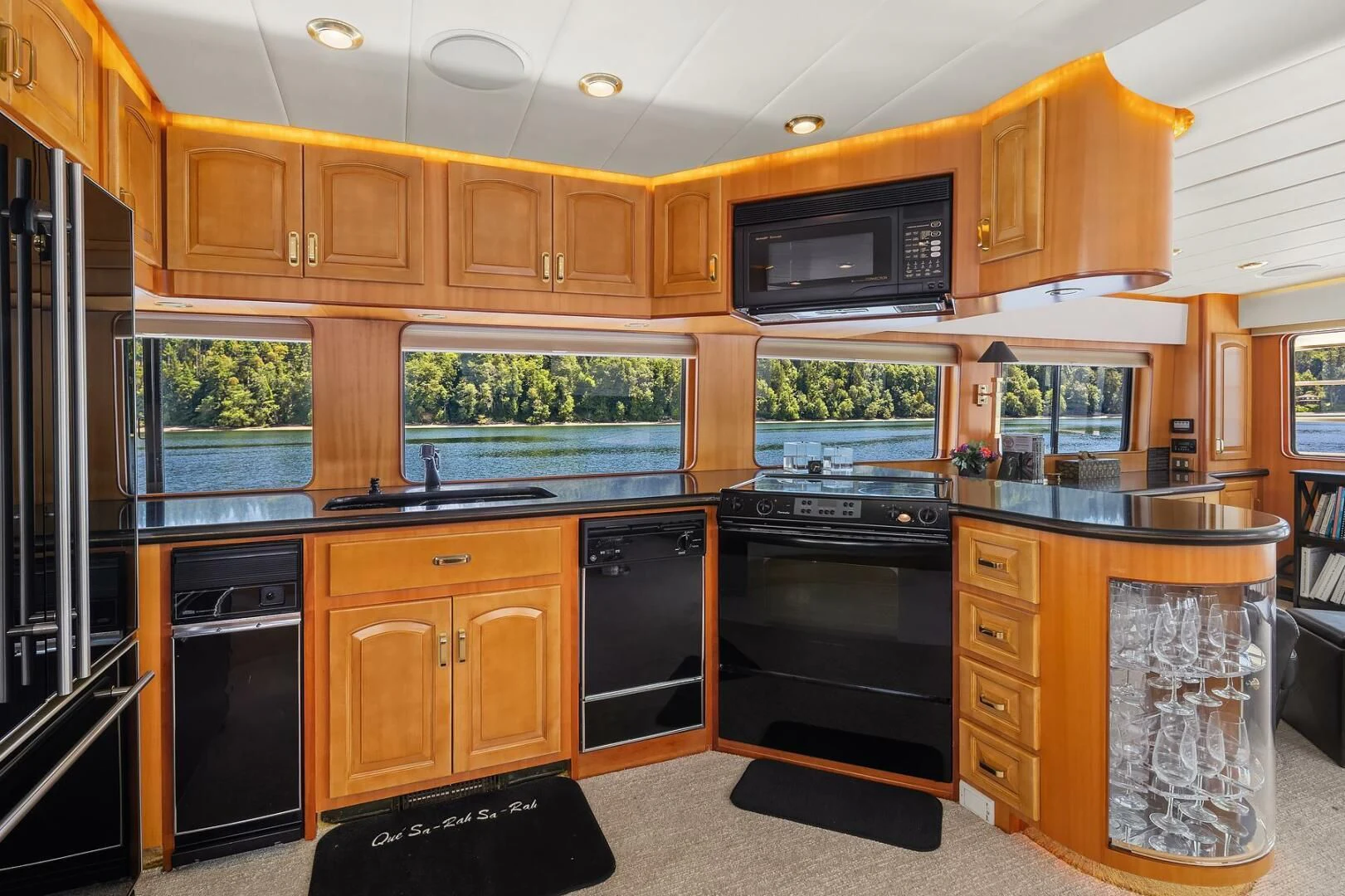 a kitchen with wooden cabinets aboard QUE SA-RAH SA-RAH Yacht for Sale