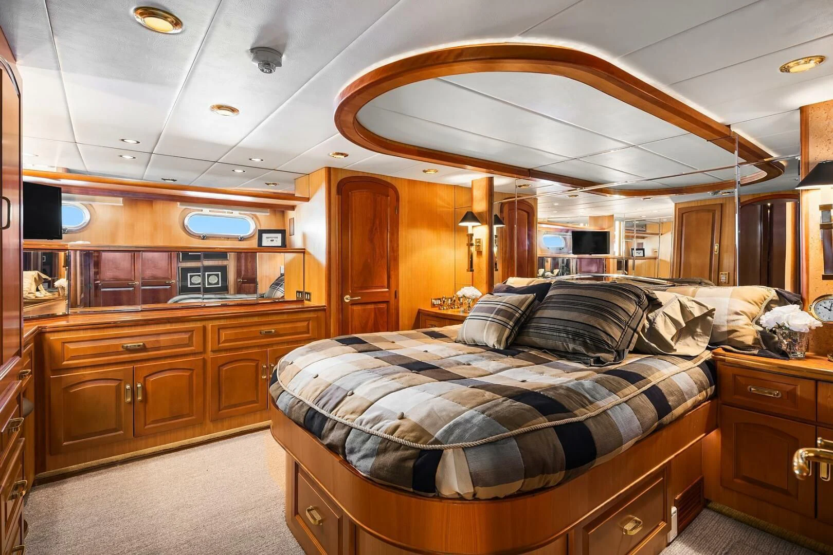 a bedroom with a bed and a large mirror aboard QUE SA-RAH SA-RAH Yacht for Sale