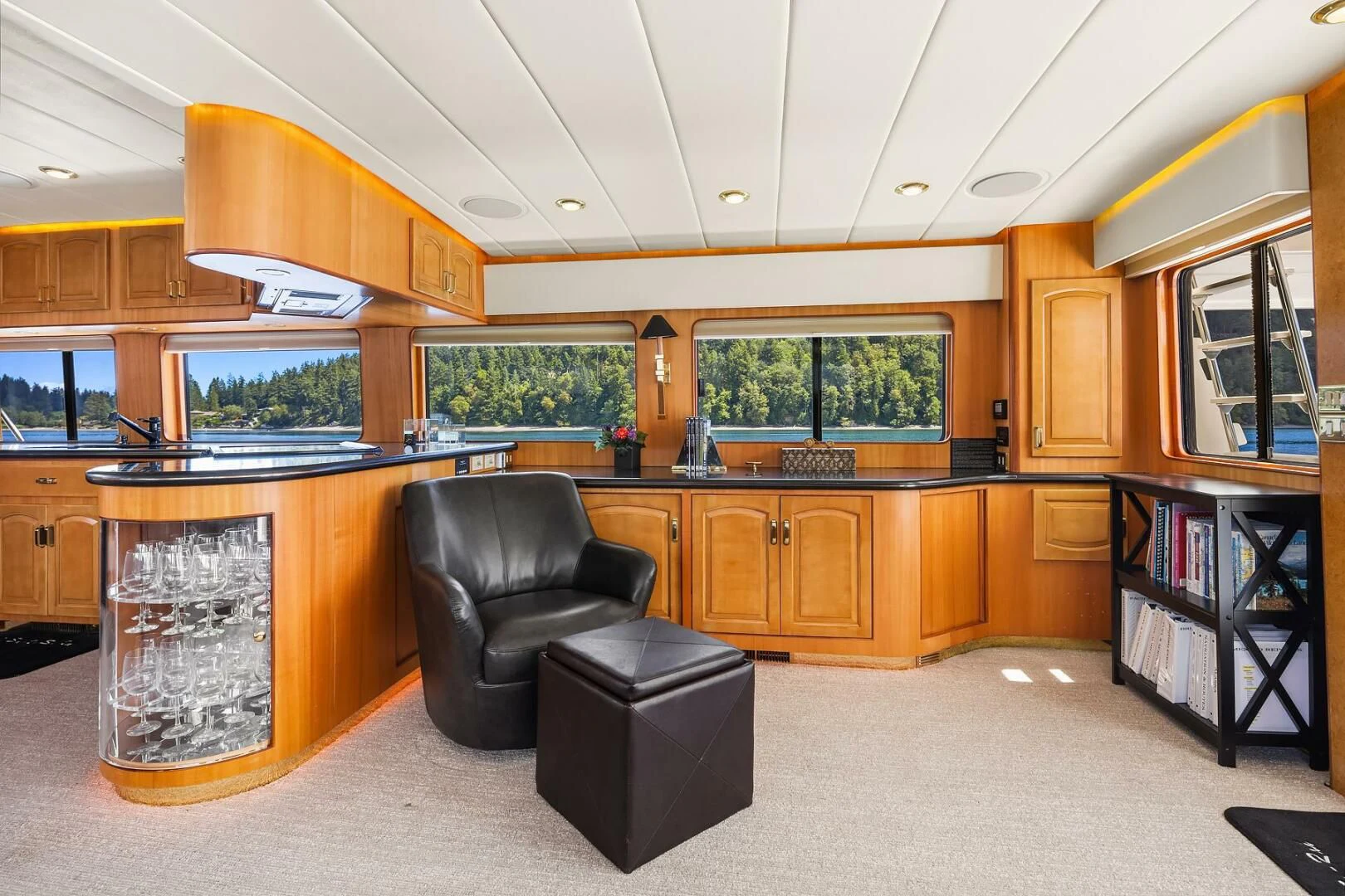a large kitchen with a black leather chair and a black chair aboard QUE SA-RAH SA-RAH Yacht for Sale