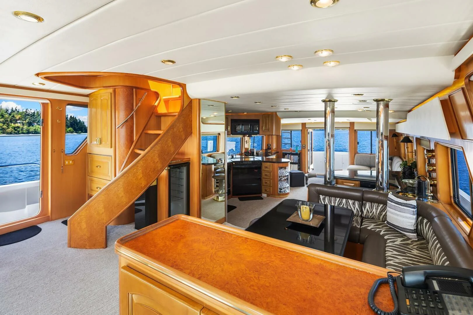 a large living room with a wood table and chairs aboard QUE SA-RAH SA-RAH Yacht for Sale
