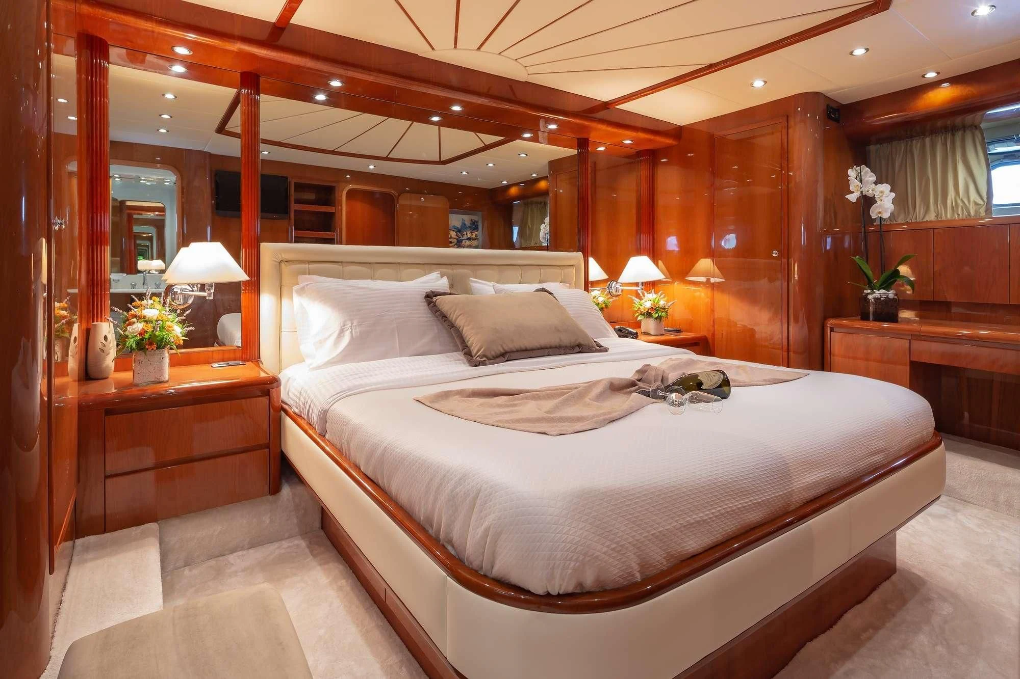 a bed with a white comforter aboard EFMARIA Yacht for Sale