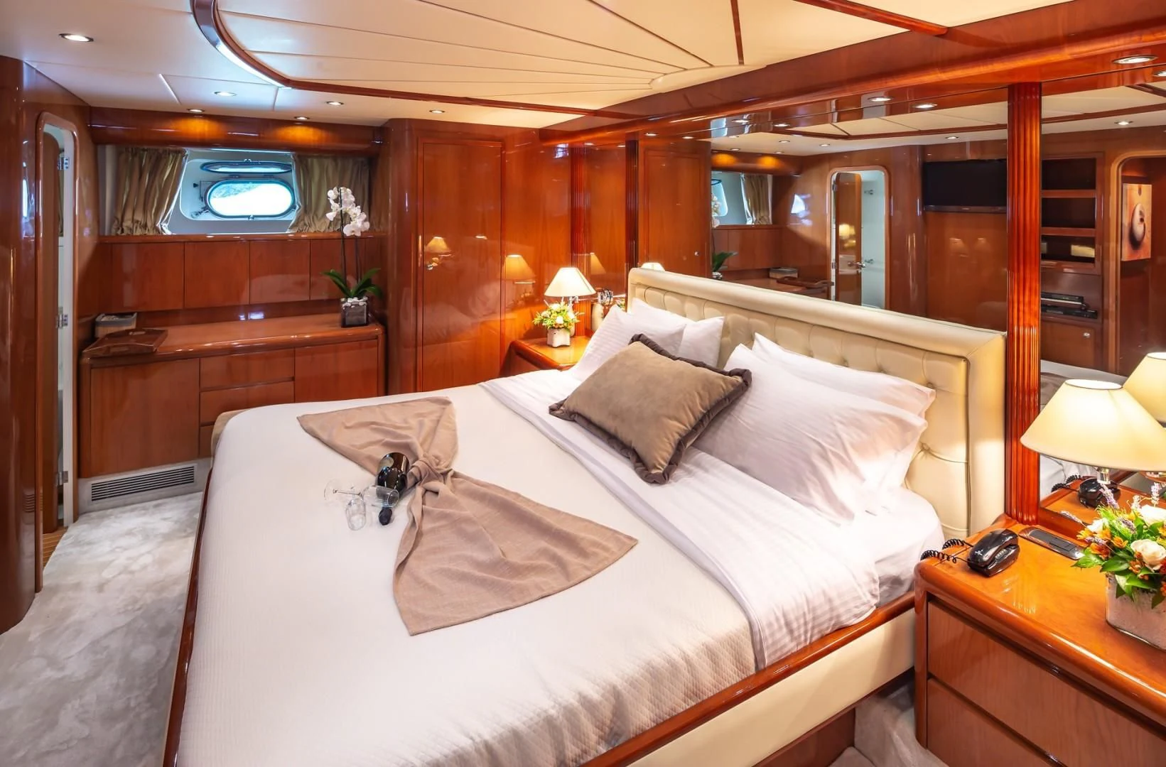 a bed with white sheets and pillows aboard EFMARIA Yacht for Sale