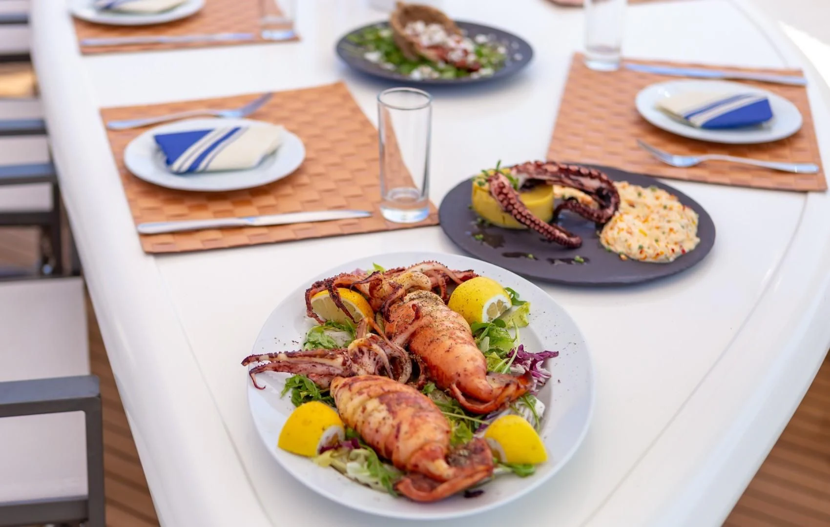 a plate of food on a table aboard EFMARIA Yacht for Sale