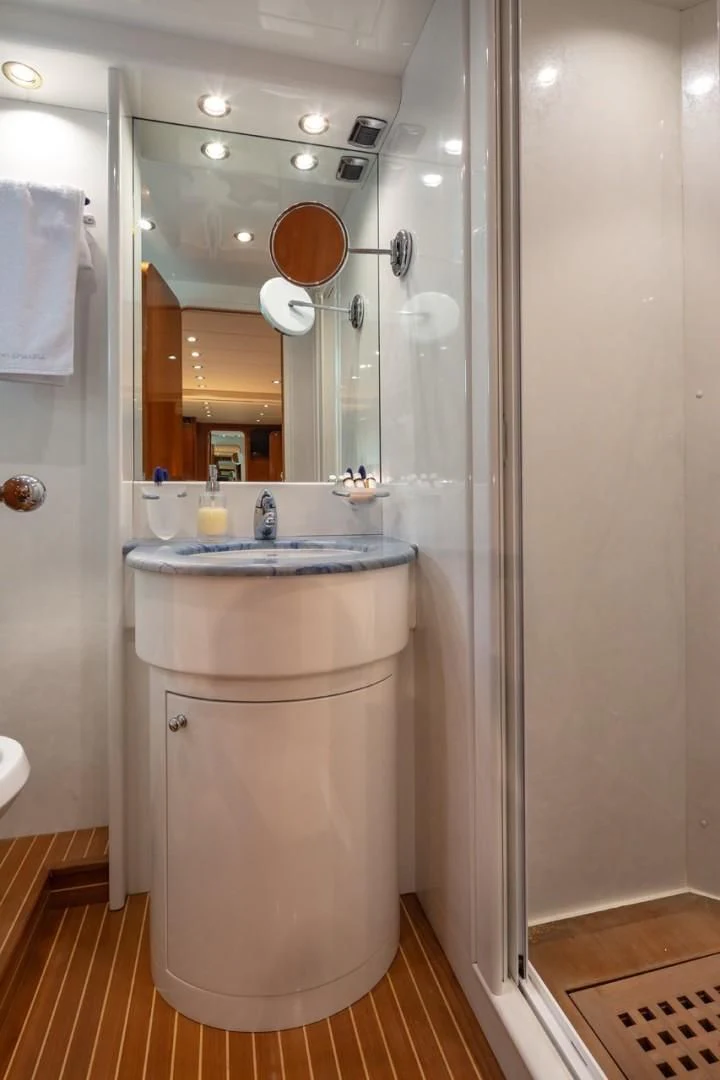 a bathroom with a sink and a shower aboard EFMARIA Yacht for Sale