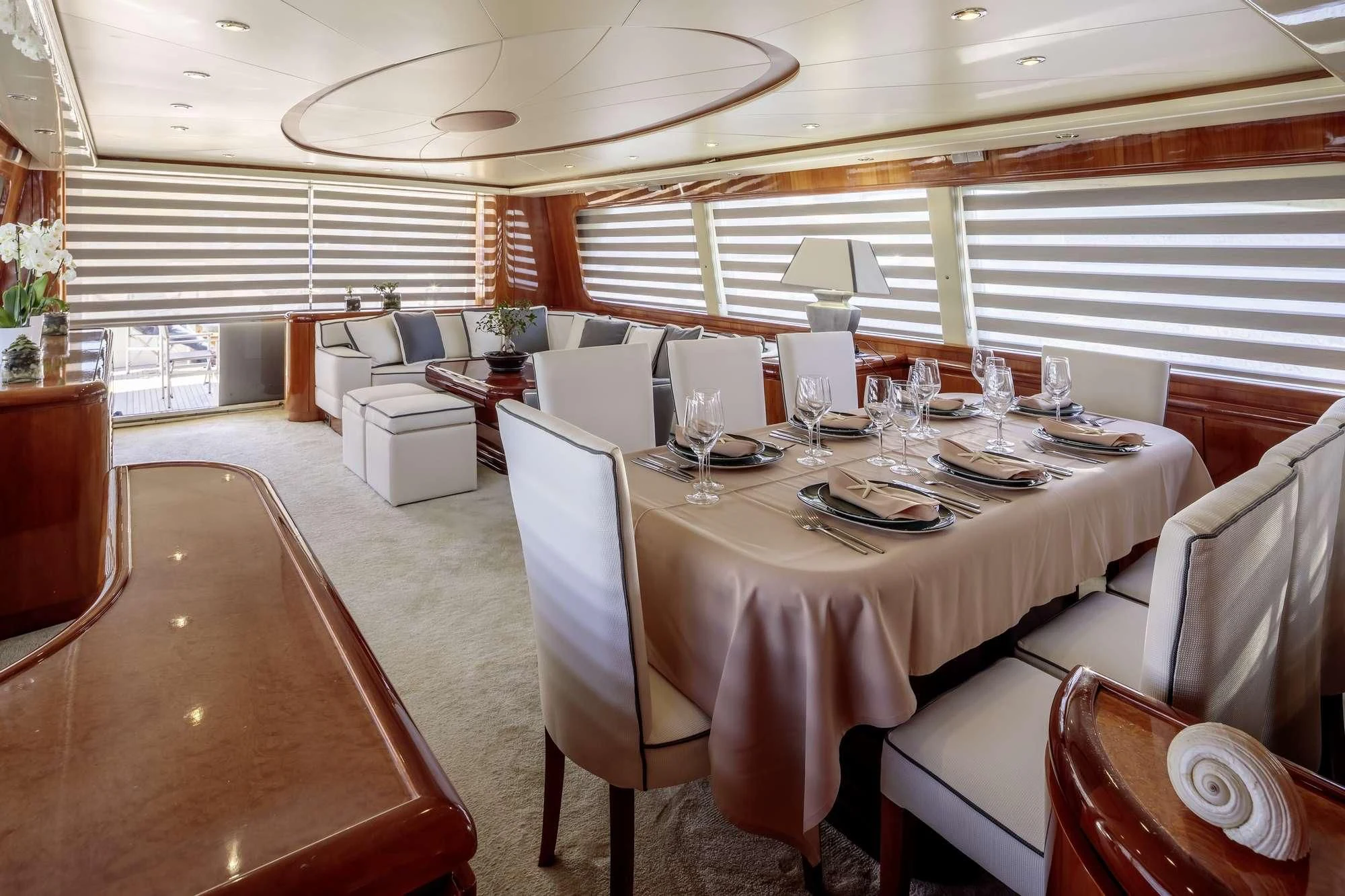 a large dining room with white chairs aboard EFMARIA Yacht for Sale