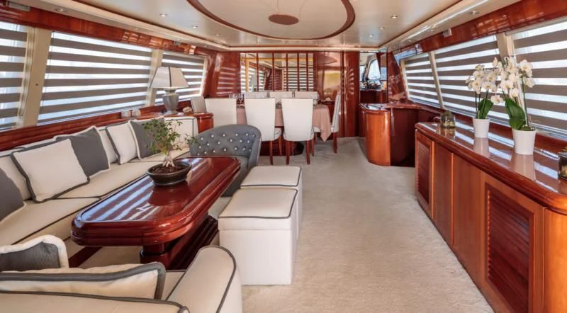 a large room with a table and chairs aboard EFMARIA Yacht for Sale