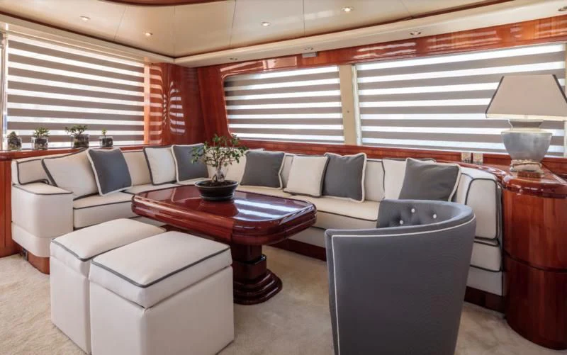 a living room with a couch and a coffee table aboard EFMARIA Yacht for Sale