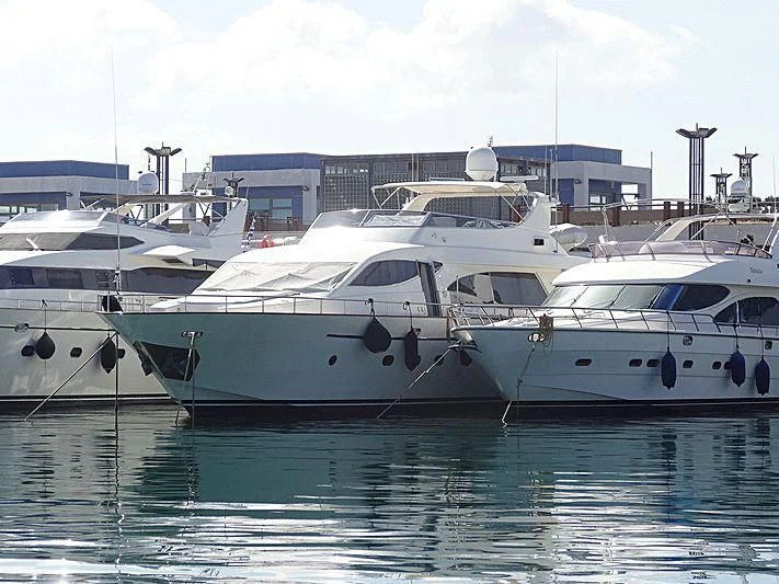 several white yachts in a harbor aboard EFMARIA Yacht for Sale