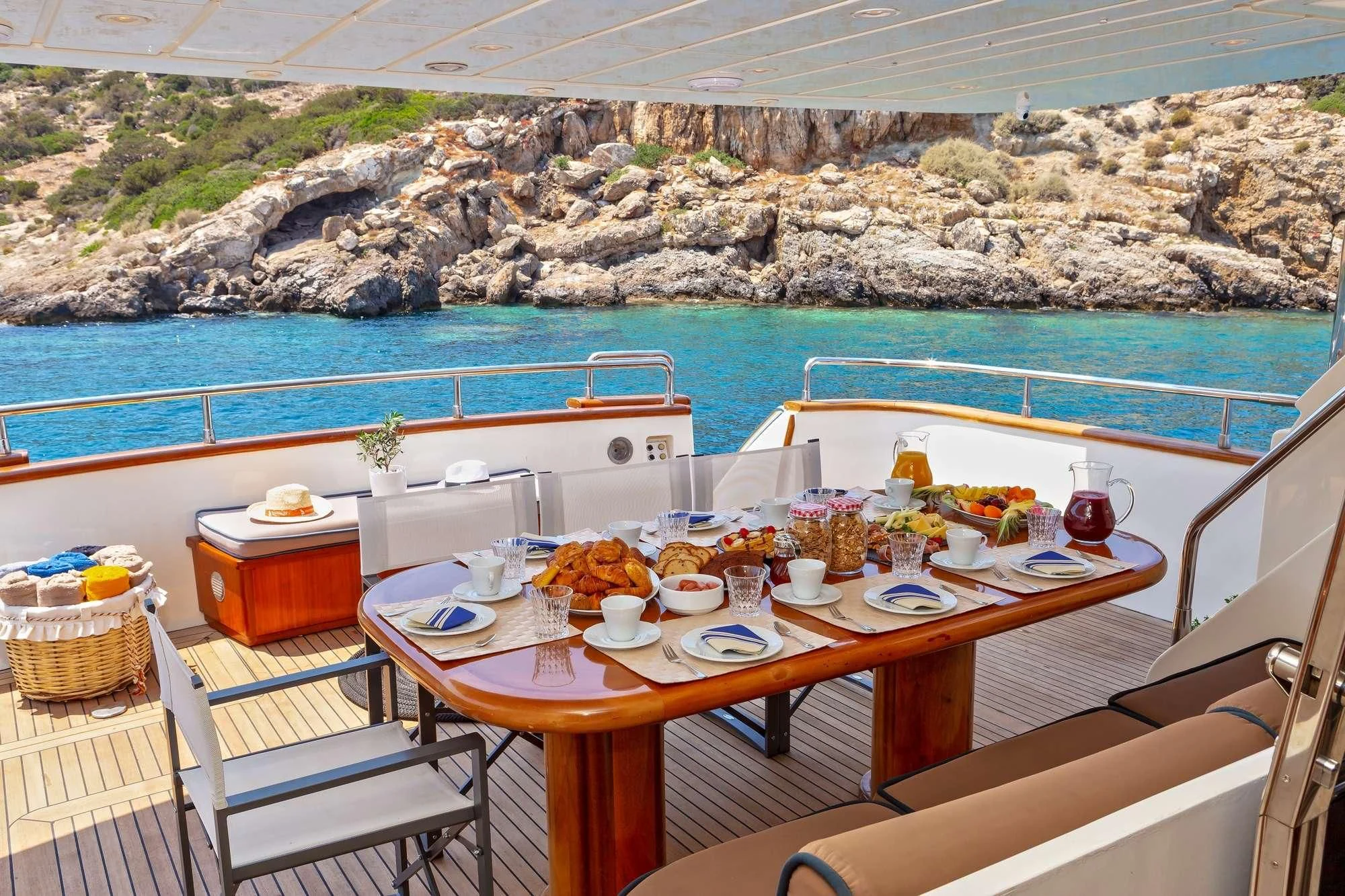 a table set for a meal on a boat aboard EFMARIA Yacht for Sale