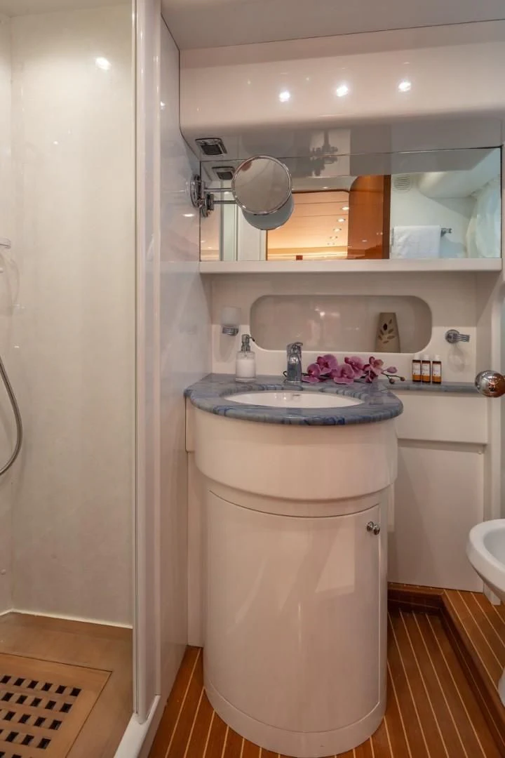 a bathroom with a sink and a mirror aboard EFMARIA Yacht for Sale