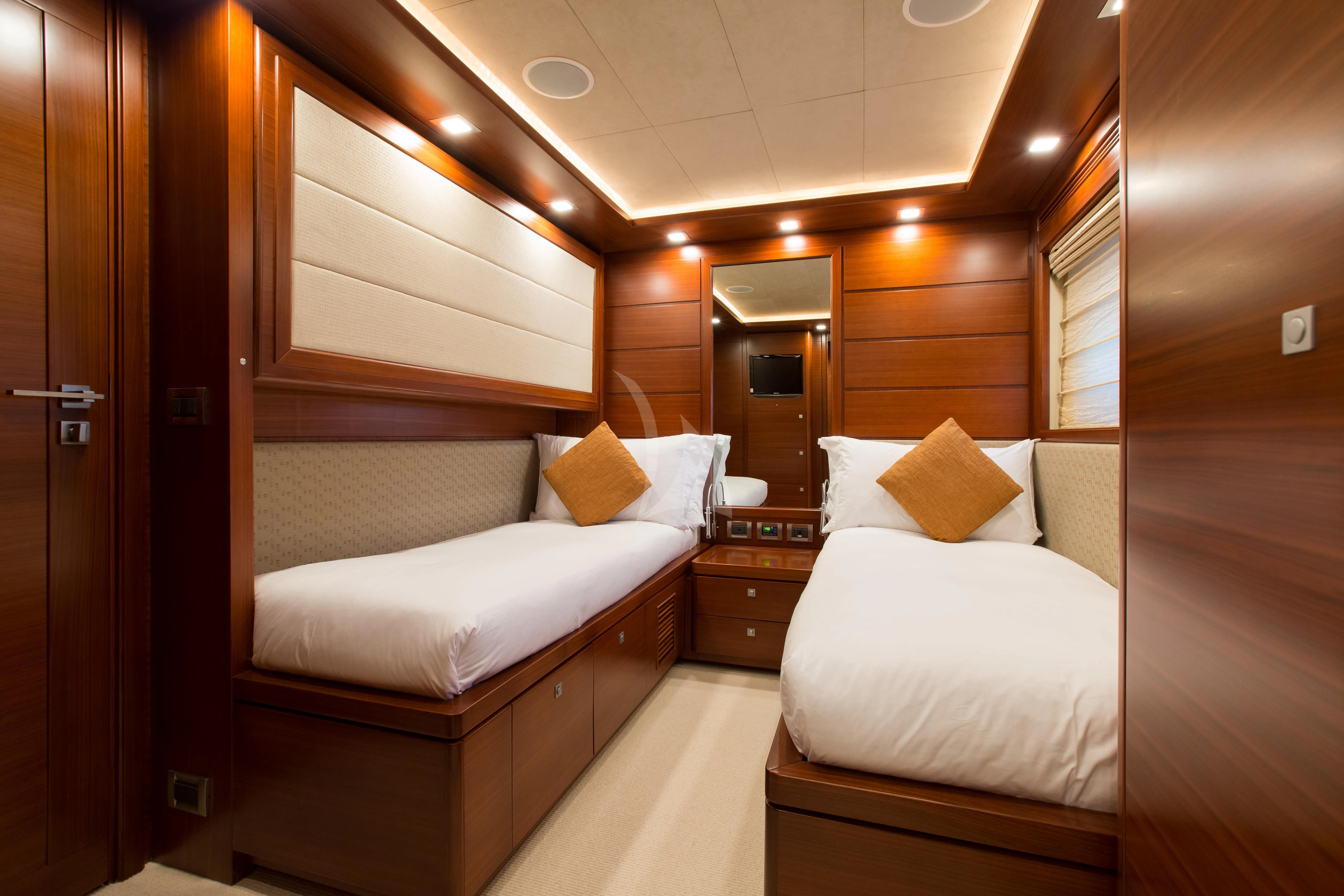 a room with a couple of beds aboard ROBUSTO Yacht for Sale