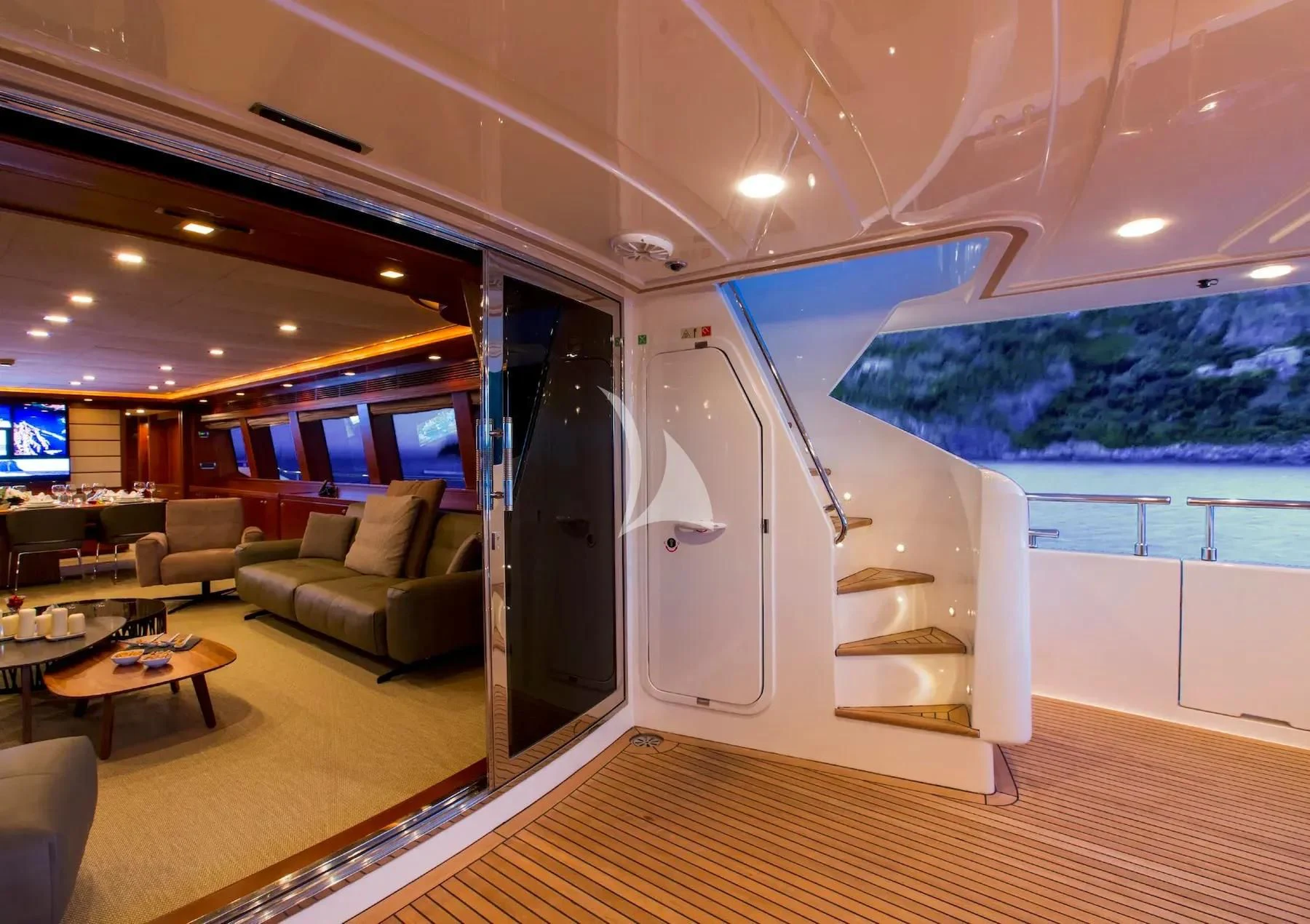 a living room with a large sliding glass door aboard ROBUSTO Yacht for Sale