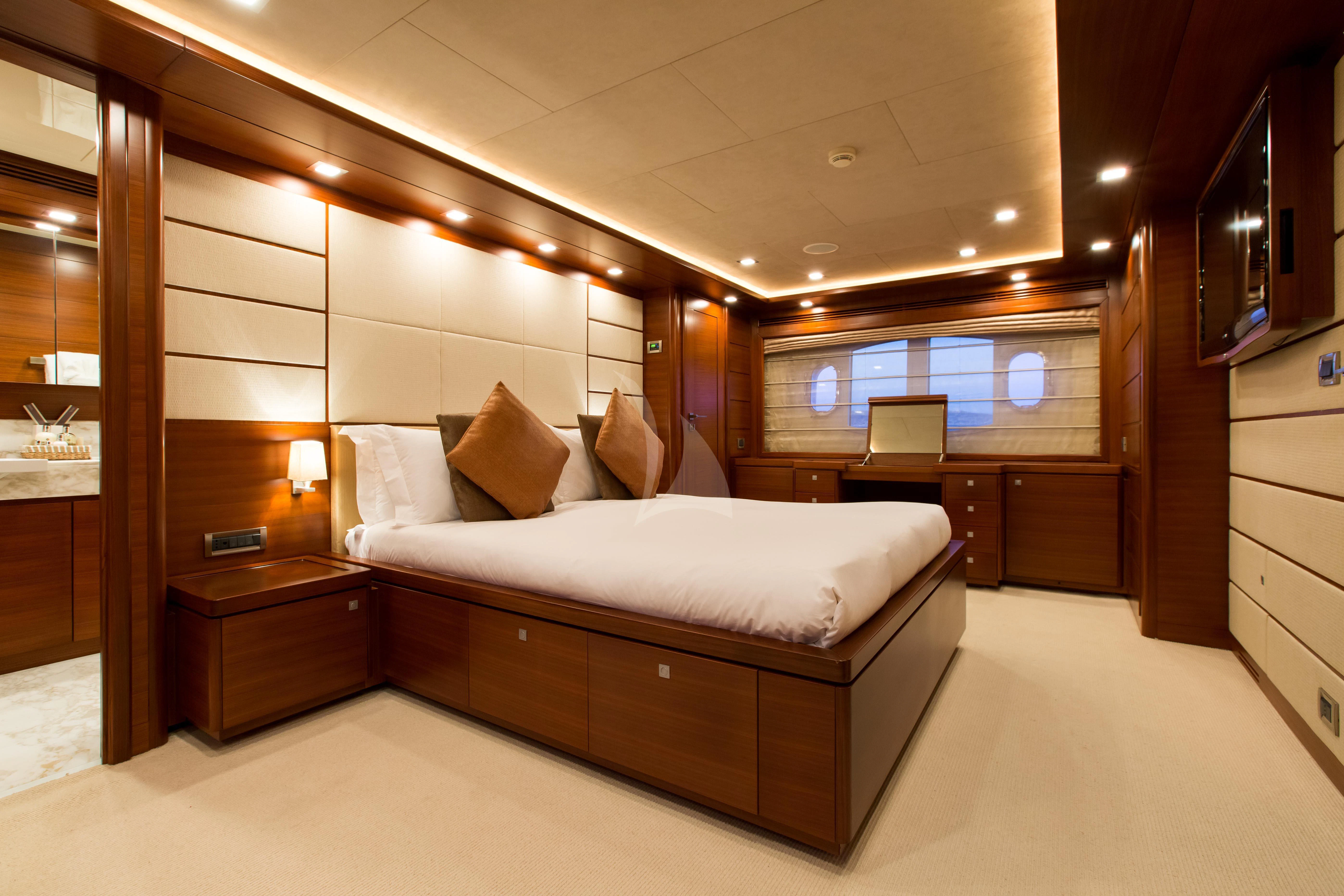 a bedroom with a bed and a desk aboard ROBUSTO Yacht for Sale