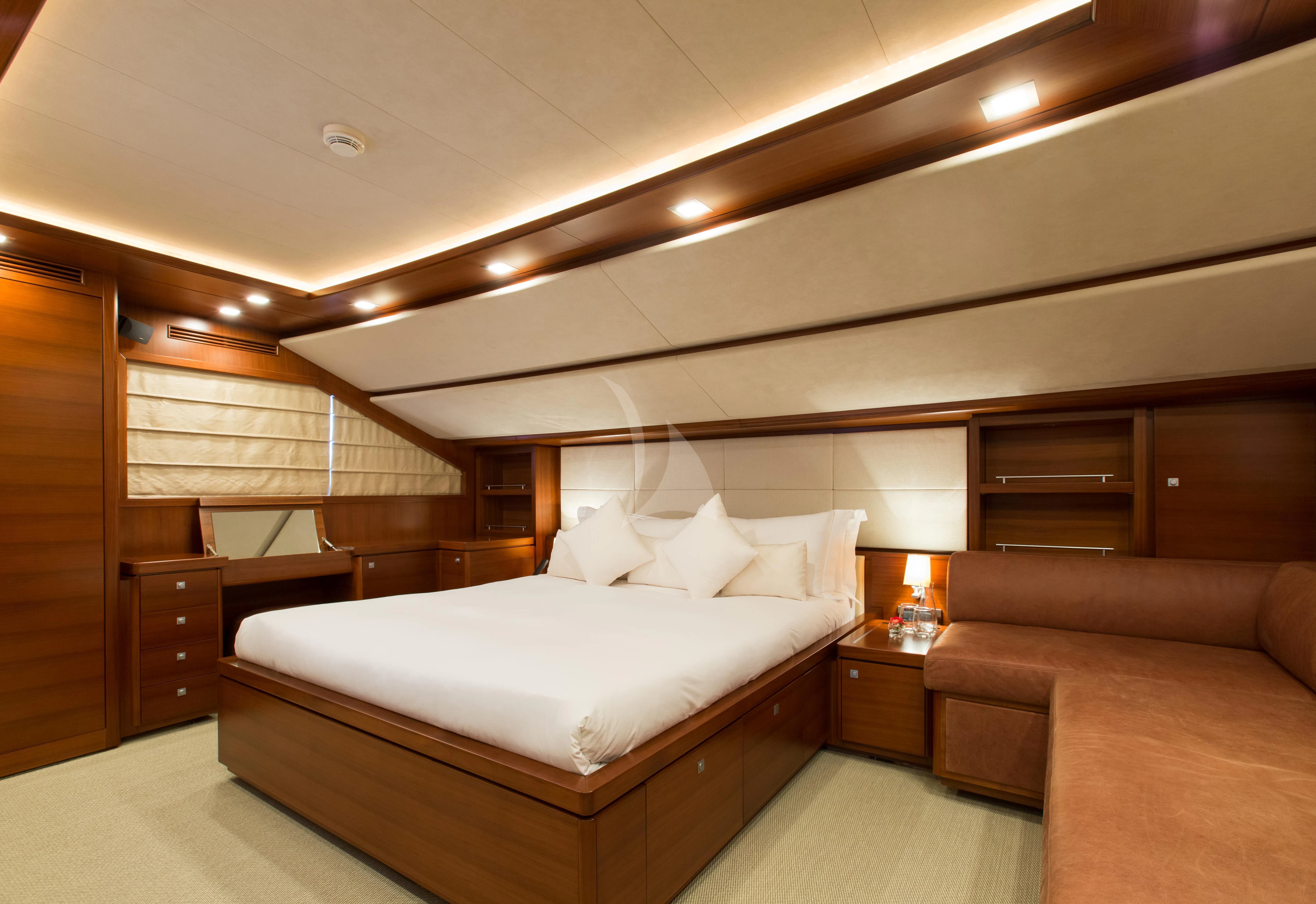a room with a bed and a couch aboard ROBUSTO Yacht for Sale