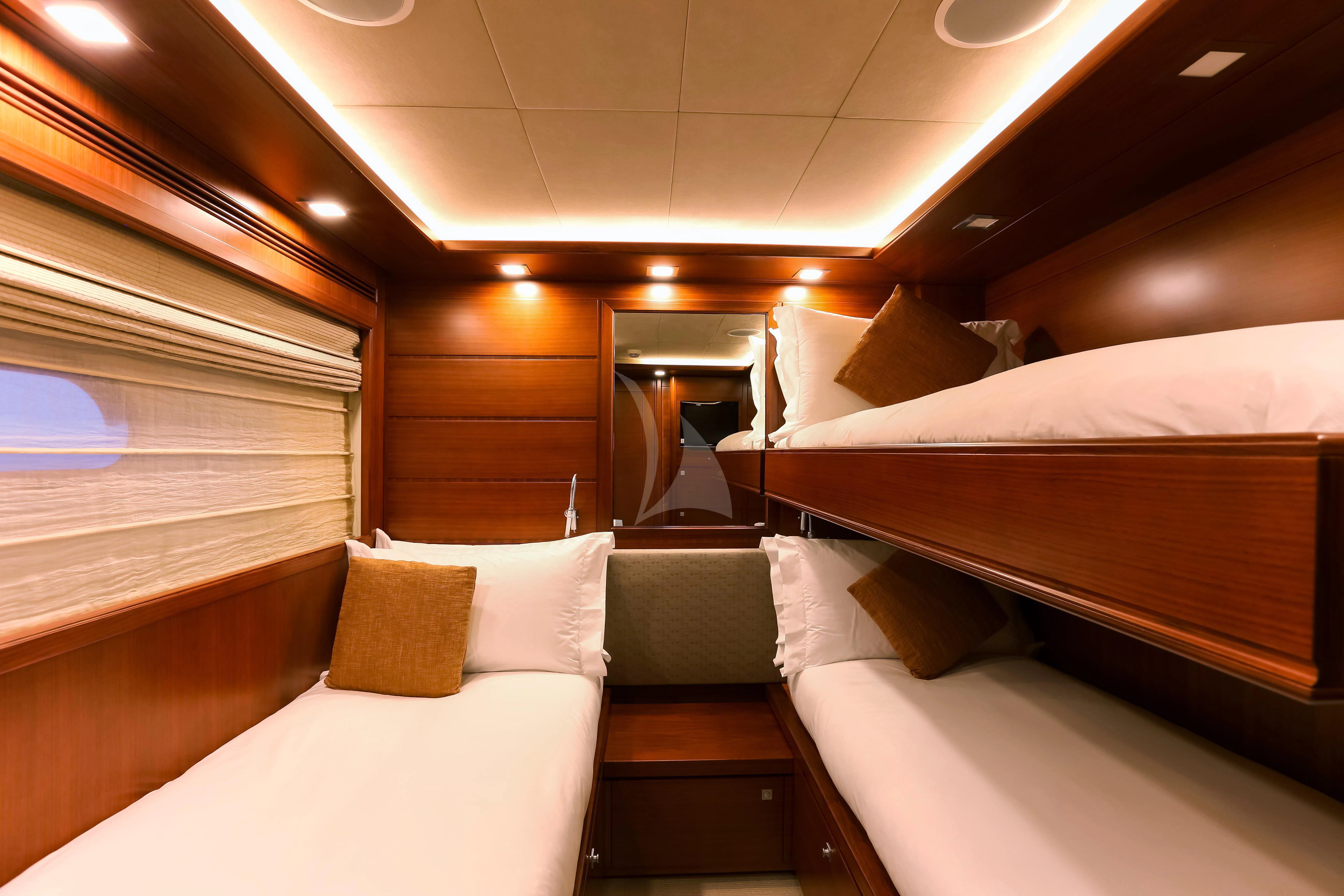 a room with beds and a mirror aboard ROBUSTO Yacht for Sale