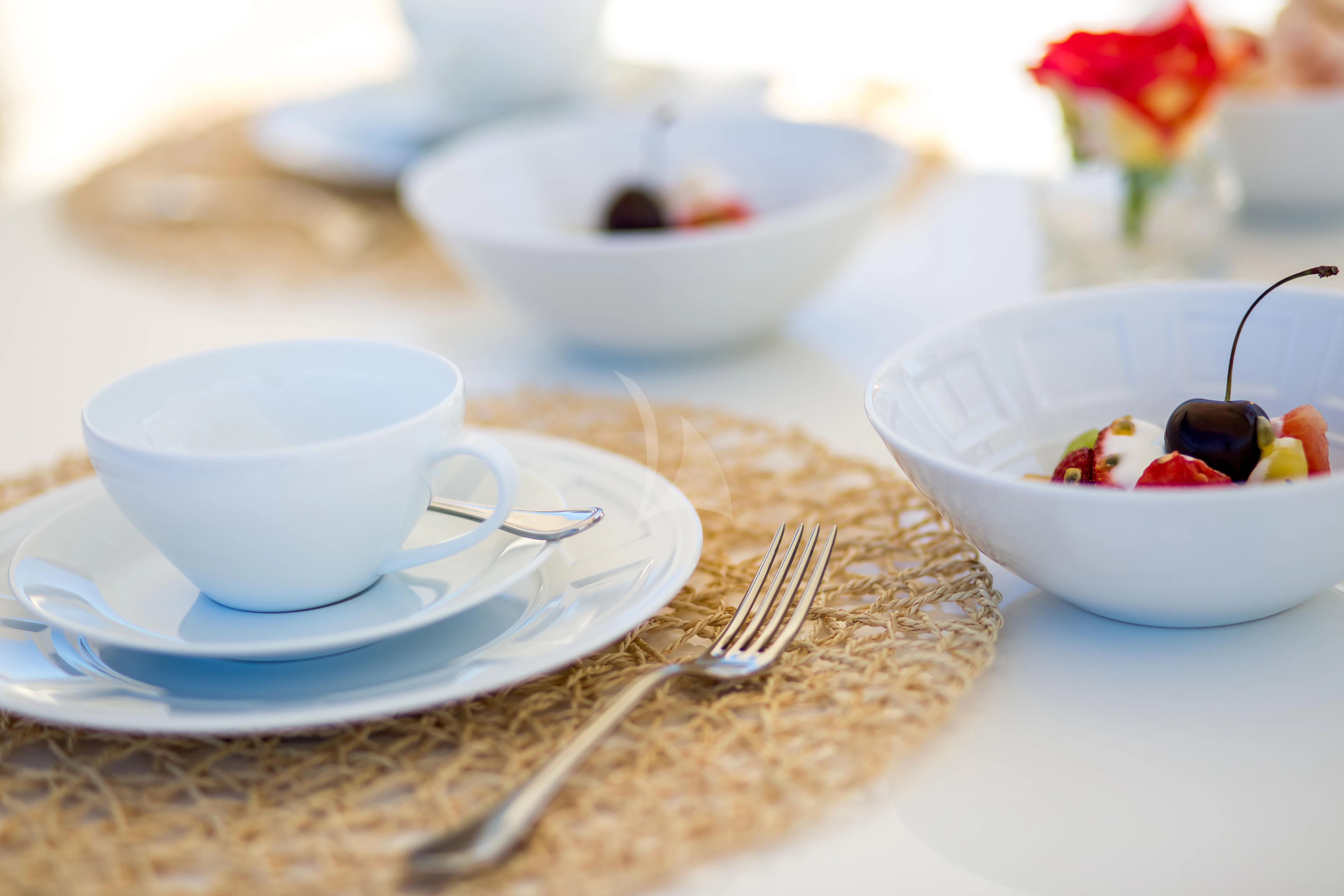 a plate of food and a bowl of fruit aboard ROBUSTO Yacht for Sale