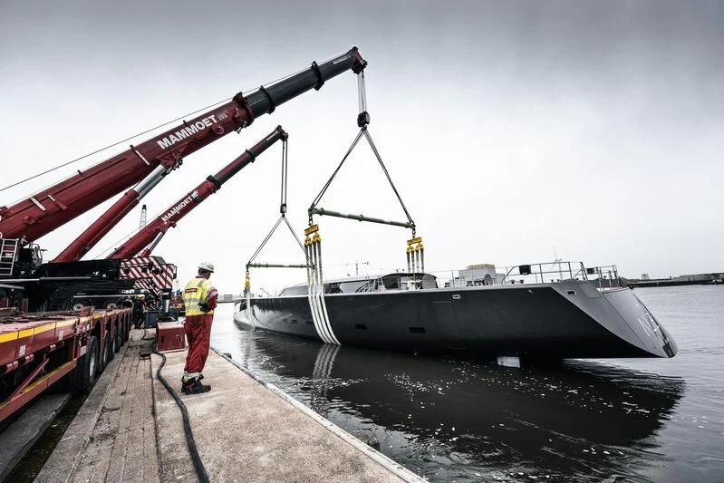 a large ship being loaded with cargo aboard ALEA Yacht for Sale