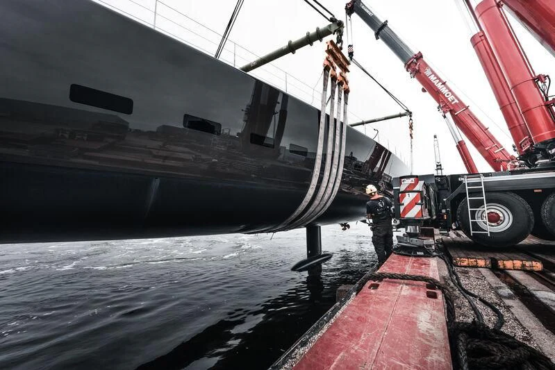 a person standing on a deck of a ship aboard ALEA Yacht for Sale