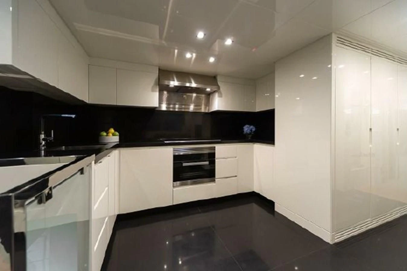 a kitchen with white cabinets aboard 2021 ASTONDOA 100 CENTURY Yacht for Sale