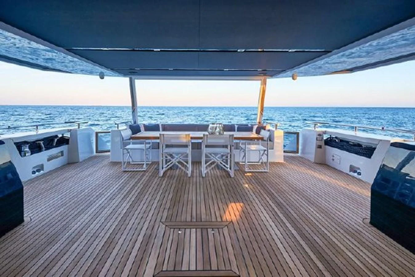 a deck with chairs and tables on it aboard 2021 ASTONDOA 100 CENTURY Yacht for Sale