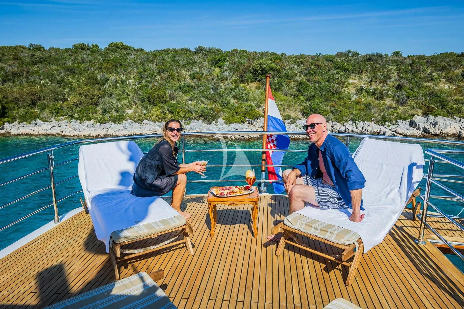 a couple sitting on a boat aboard AURIANE Yacht for Sale