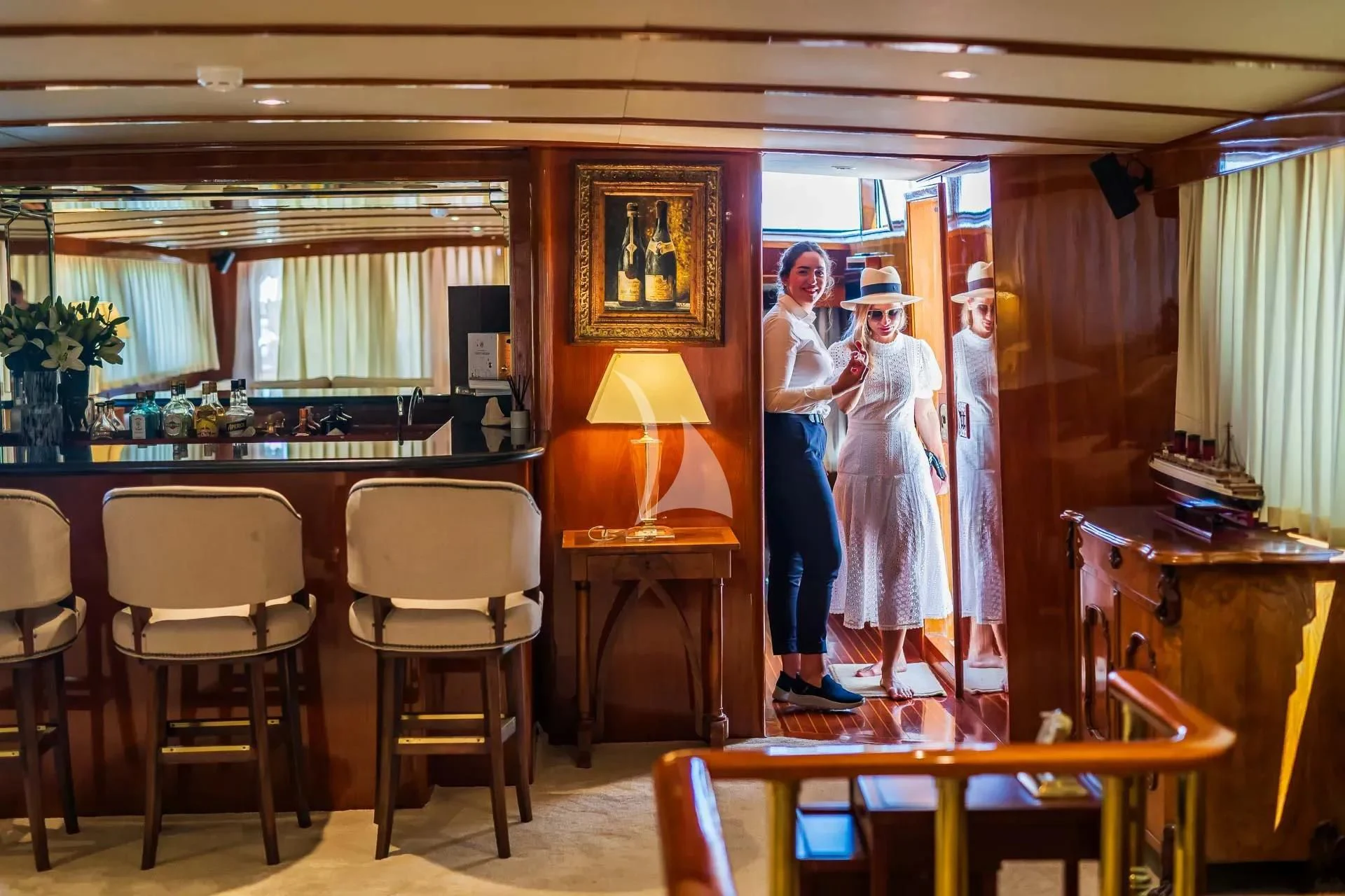 a group of people standing in a room with tables and chairs aboard AURIANE Yacht for Sale