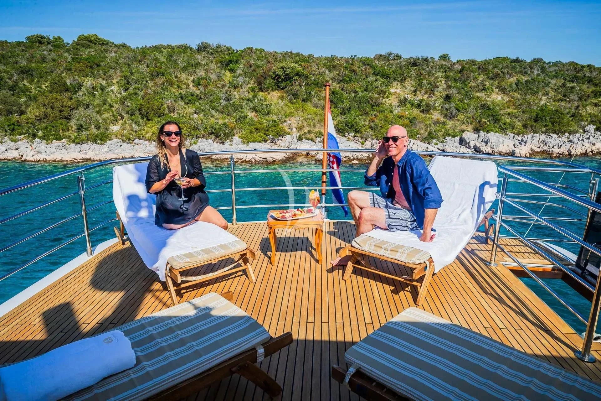 a couple of people sitting on a boat on the water aboard AURIANE Yacht for Sale