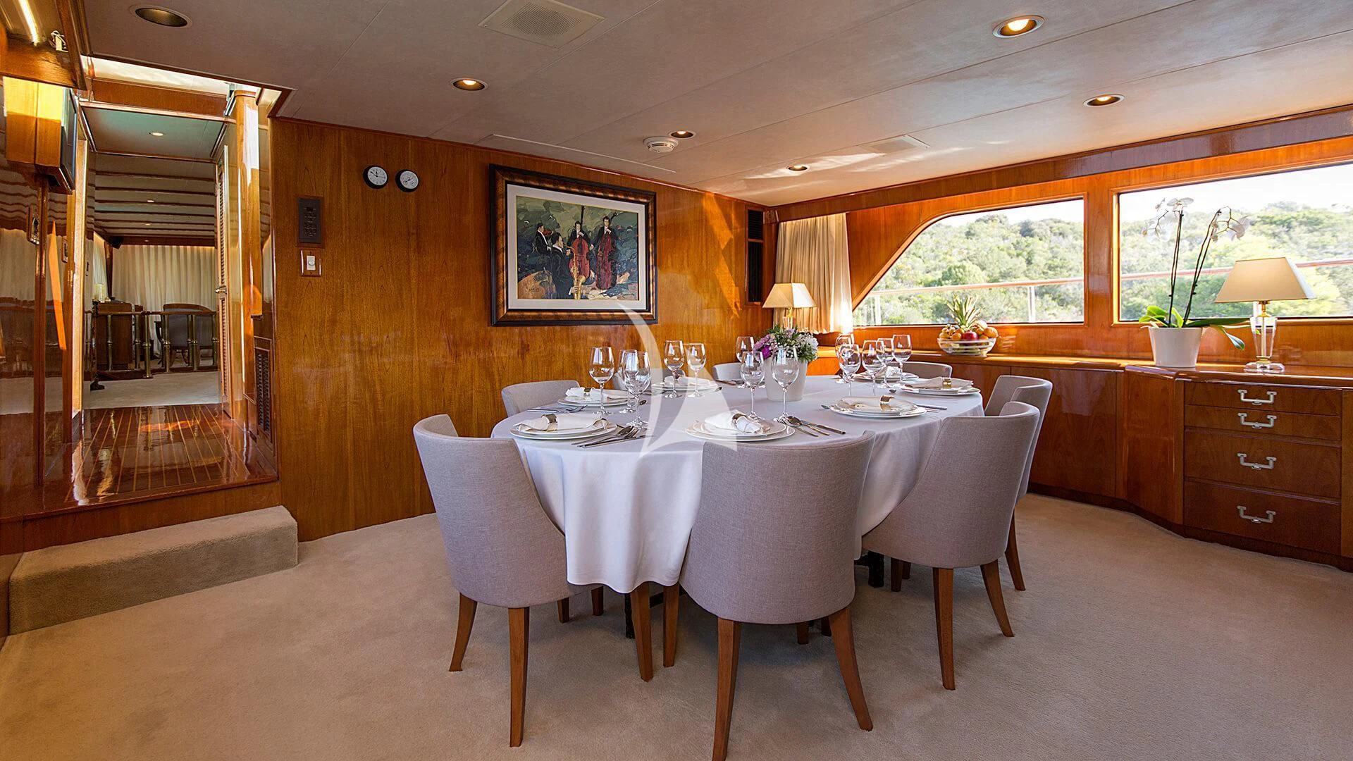 a large dining table in a large room with a large window aboard AURIANE Yacht for Sale