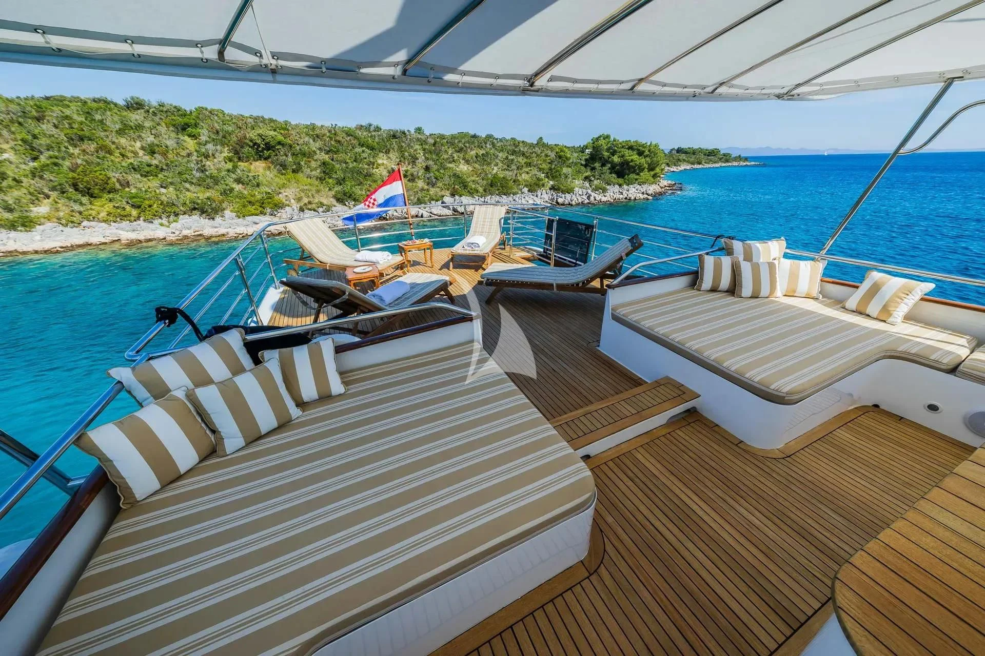 a deck with lounge chairs on it aboard AURIANE Yacht for Sale