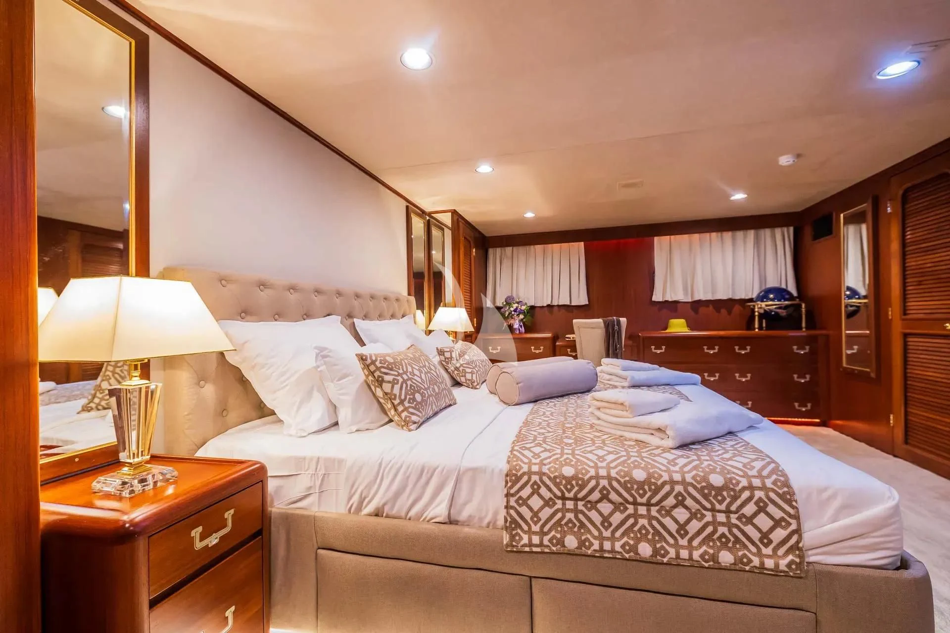 a hotel room with a bed and lamps aboard AURIANE Yacht for Sale
