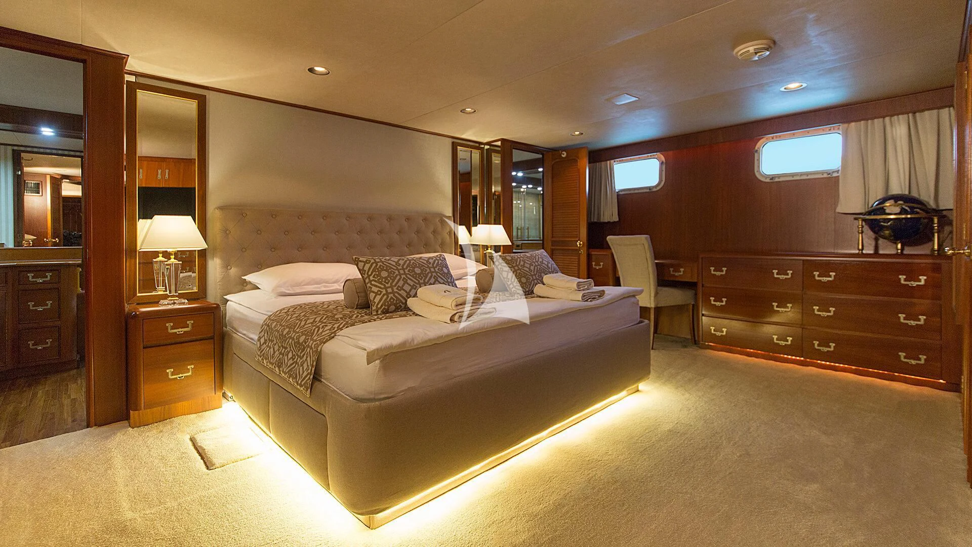 a large bedroom with a bed and a desk aboard AURIANE Yacht for Sale