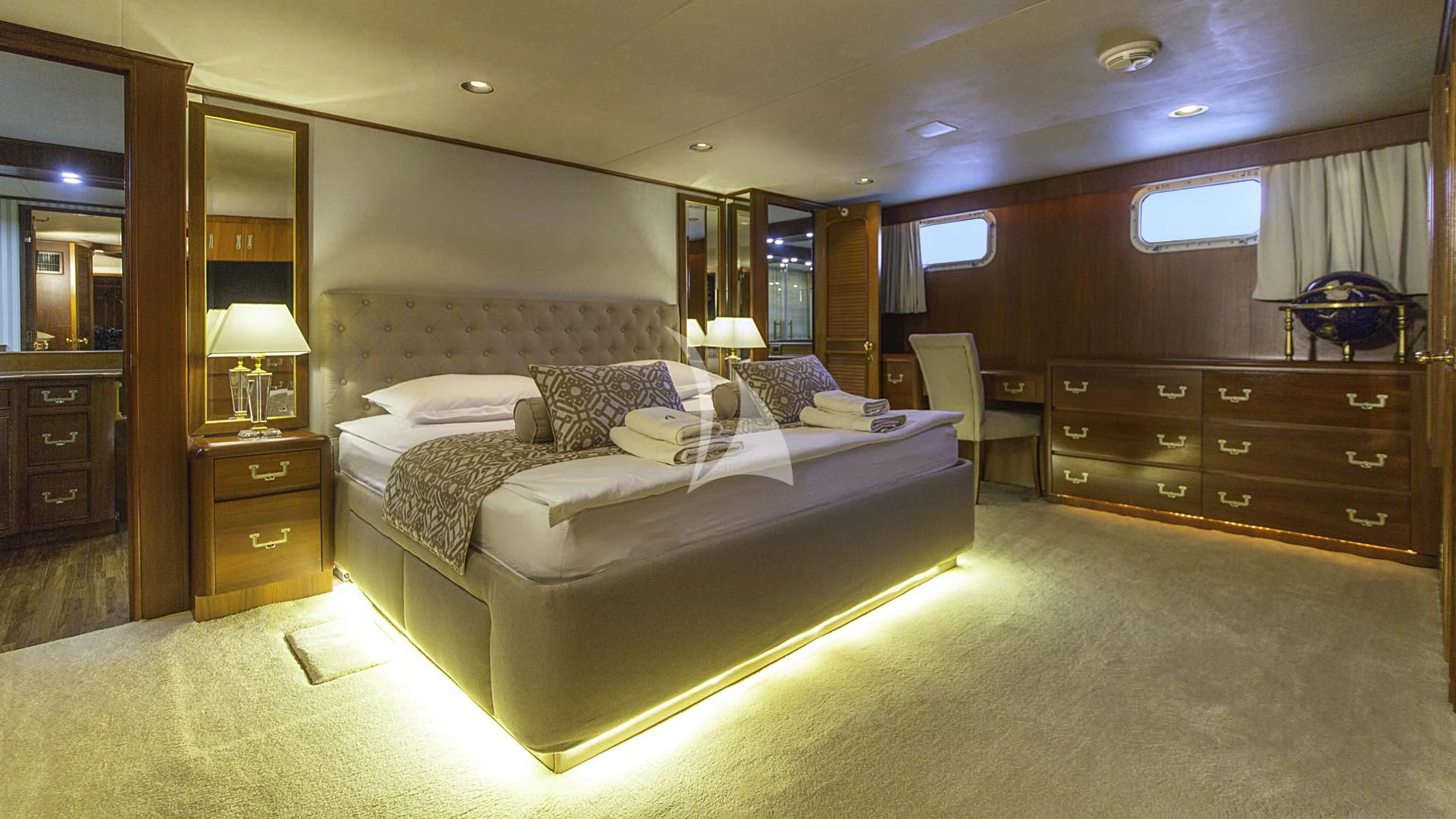 a large bedroom with a bed and a desk aboard AURIANE Yacht for Sale
