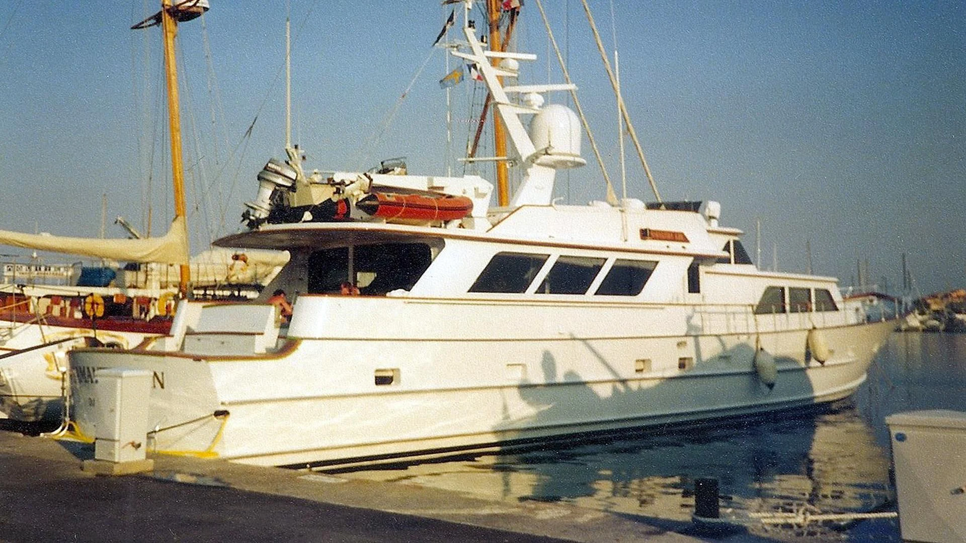a white boat on a dock aboard AURIANE Yacht for Sale