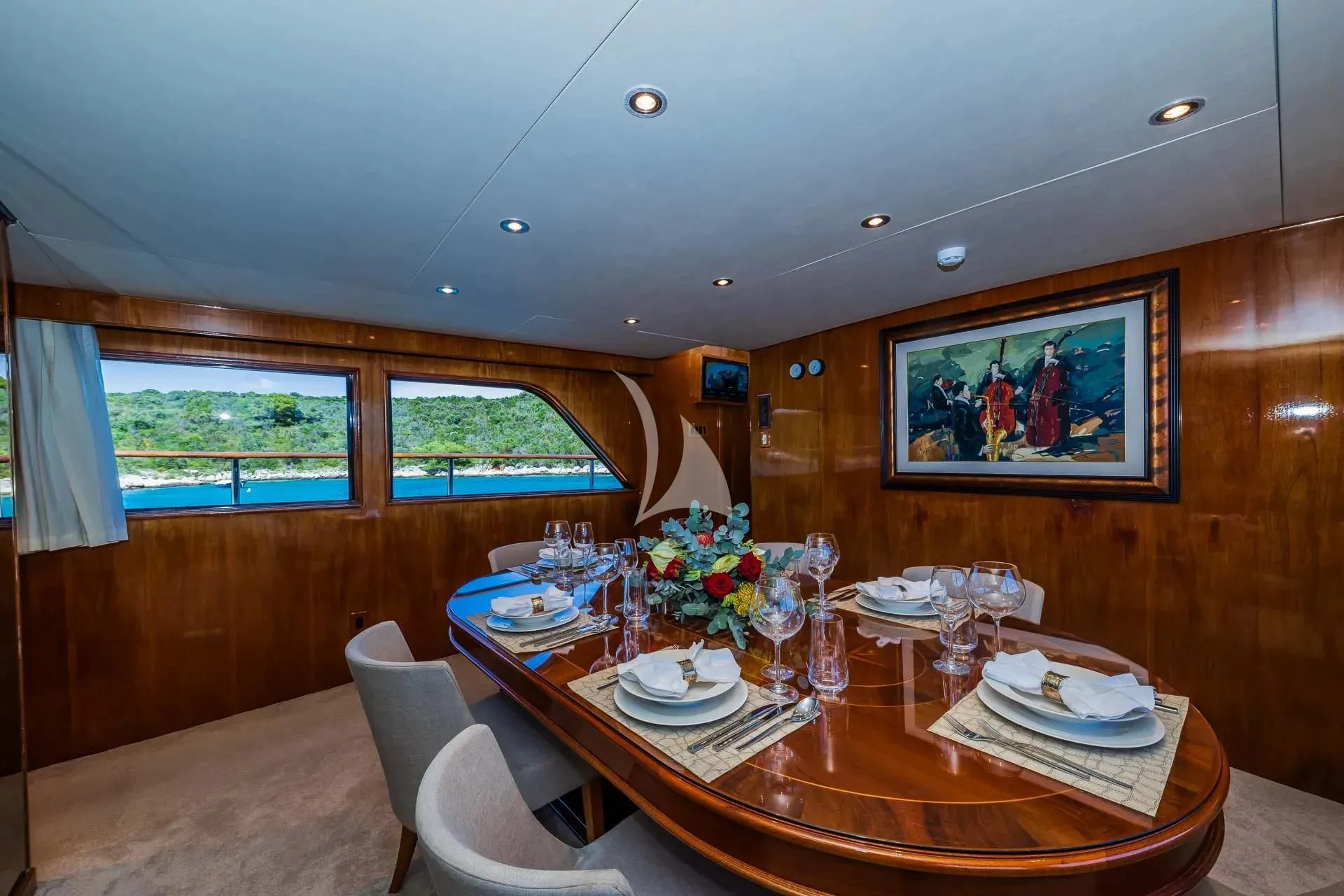 a dining table with plates and glasses aboard AURIANE Yacht for Sale